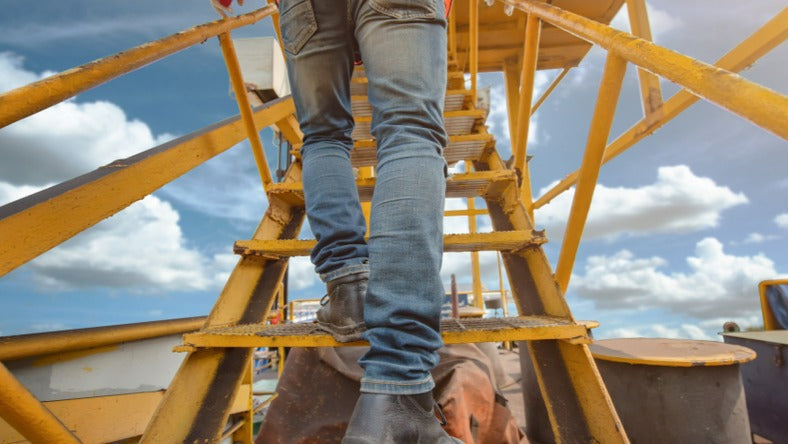 Construction work walking up stairs